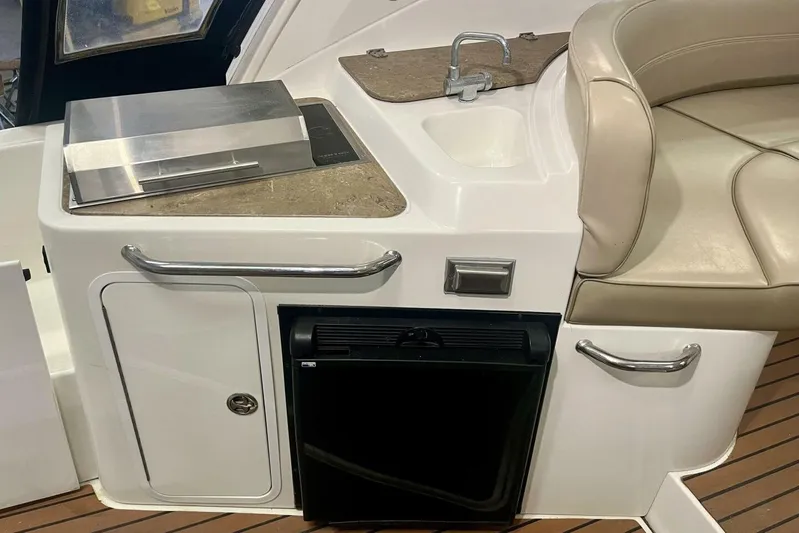  Yacht Photos Pics 2011 Cruisers Yachts 330 Express interior with kitchenette, sink, and seating area.