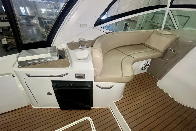  Yacht Photos Pics 2011 Cruisers Yachts 330 Express interior with seating, sink, and wooden flooring.
