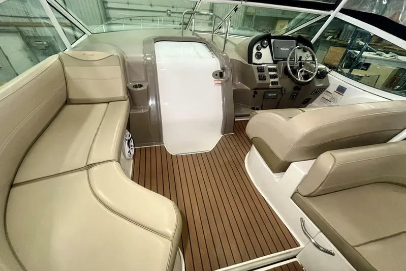  Yacht Photos Pics 2011 Cruisers Yachts 330 Express interior with beige seating and wood flooring.