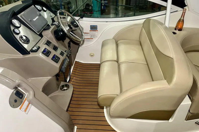  Yacht Photos Pics 2011 Cruisers Yachts 330 Express helm with beige seating and wood flooring.