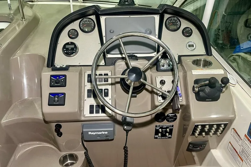  Yacht Photos Pics 2011 Cruisers Yachts 330 Express helm with steering wheel and control panel.