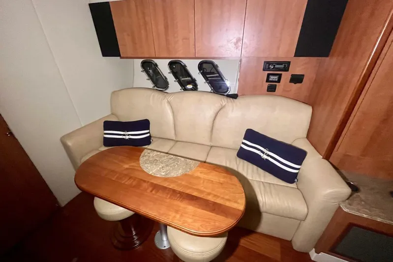  Yacht Photos Pics Luxurious interior of 2011 Cruisers Yachts 330 Express with beige sofa and wooden table.