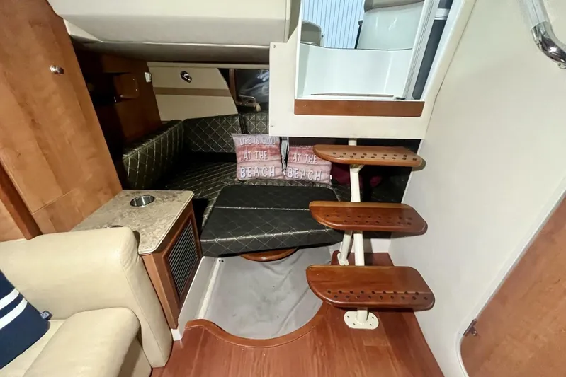  Yacht Photos Pics Interior of 2011 Cruisers Yachts 330 Express with cozy seating and wooden steps.