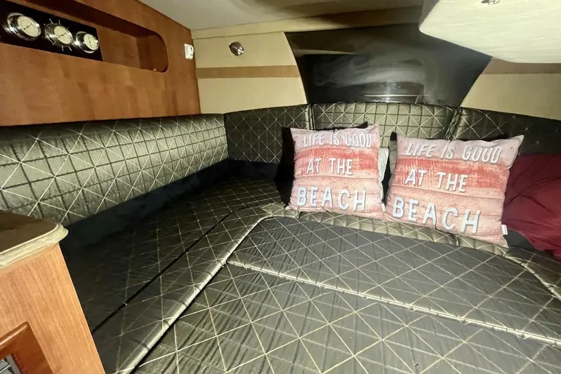  Yacht Photos Pics Luxurious 2011 Cruisers Yachts 330 Express cabin with cozy bedding and beach-themed pillows.