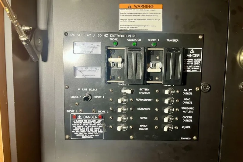  Yacht Photos Pics Electrical panel of 2011 Cruisers Yachts 330 Express, featuring switches and warning labels.