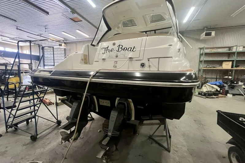  Yacht Photos Pics 2011 Cruisers Yachts 330 Express in a workshop, rear view with "The Boat" nameplate.