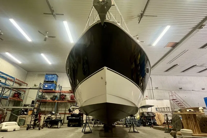  Yacht Photos Pics 2011 Cruisers Yachts 330 Express in a well-lit indoor storage facility.