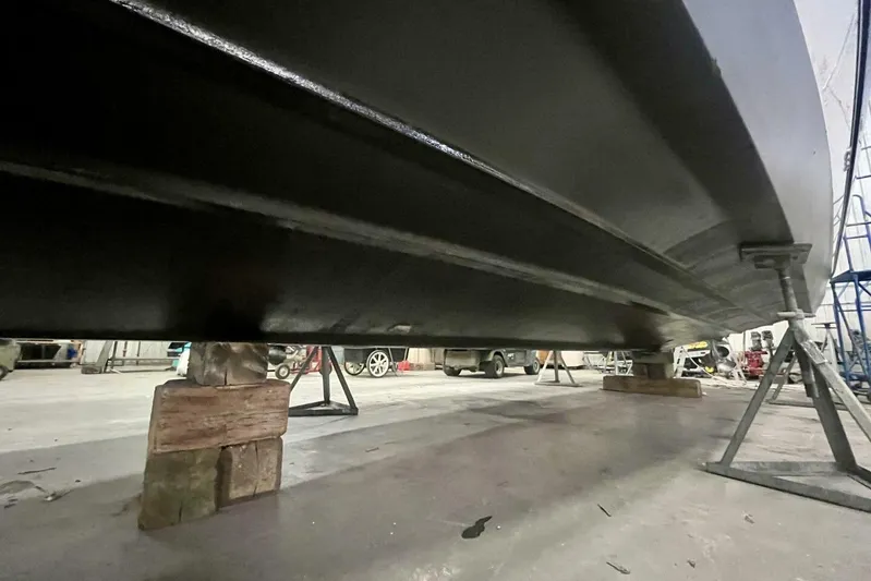  Yacht Photos Pics 2011 Cruisers Yachts 330 Express hull on supports in a workshop.