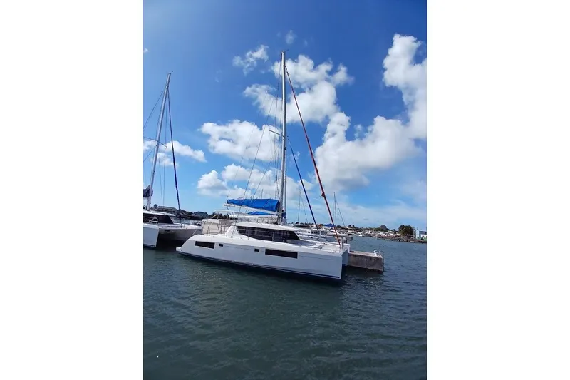 Mere Cat Yacht Photos Pics 2018 Leopard 45 catamaran docked in a marina under a clear blue sky.