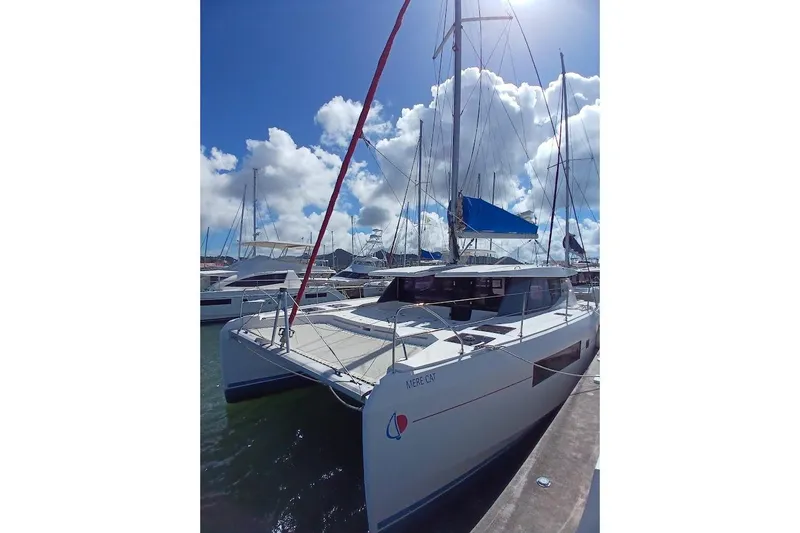 Mere Cat Yacht Photos Pics 2018 Leopard 45 catamaran docked under a bright blue sky.