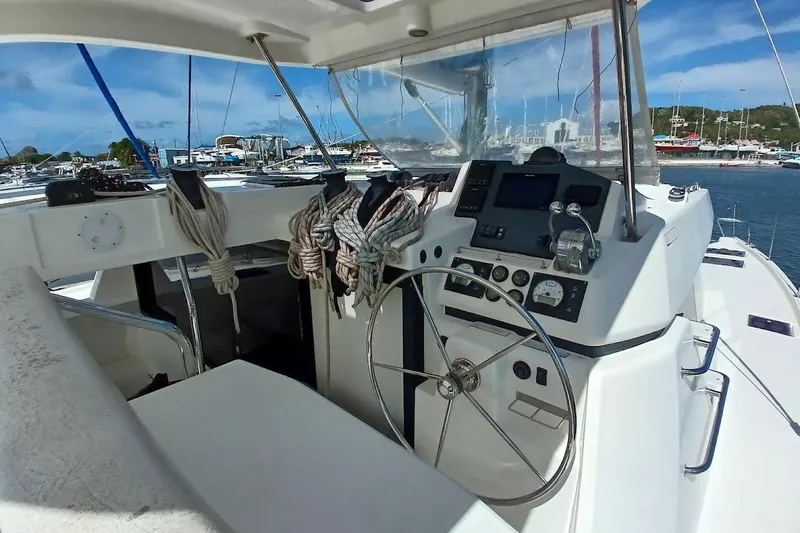 Mere Cat Yacht Photos Pics 2018 Leopard 45 yacht cockpit with steering wheel and marina view.