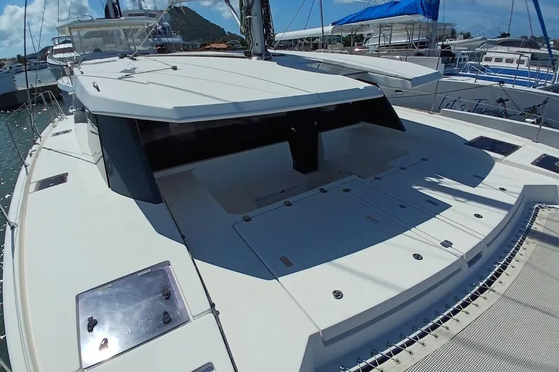 Mere Cat Yacht Photos Pics 2018 Leopard 45 catamaran docked, showcasing spacious deck and sleek design.