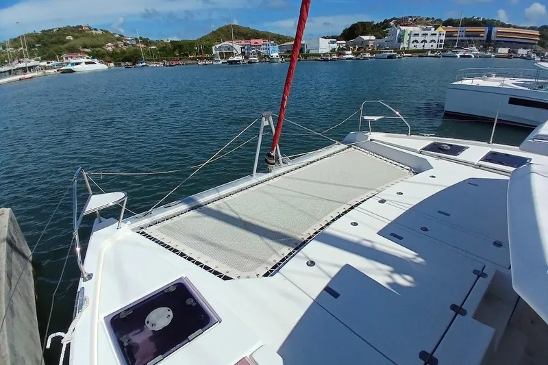 Mere Cat Yacht Photos Pics 2018 Leopard 45 catamaran docked in a scenic marina with clear blue skies.