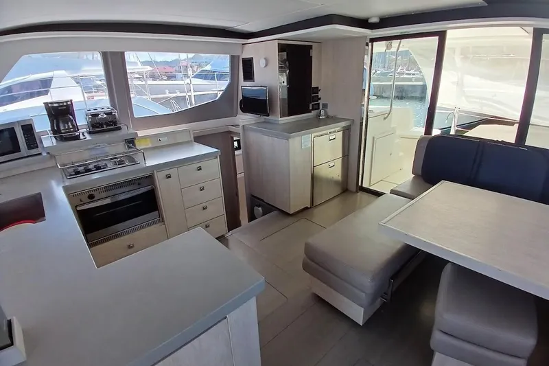 Mere Cat Yacht Photos Pics Luxurious interior of 2018 Leopard 45 yacht with modern kitchen and dining area.