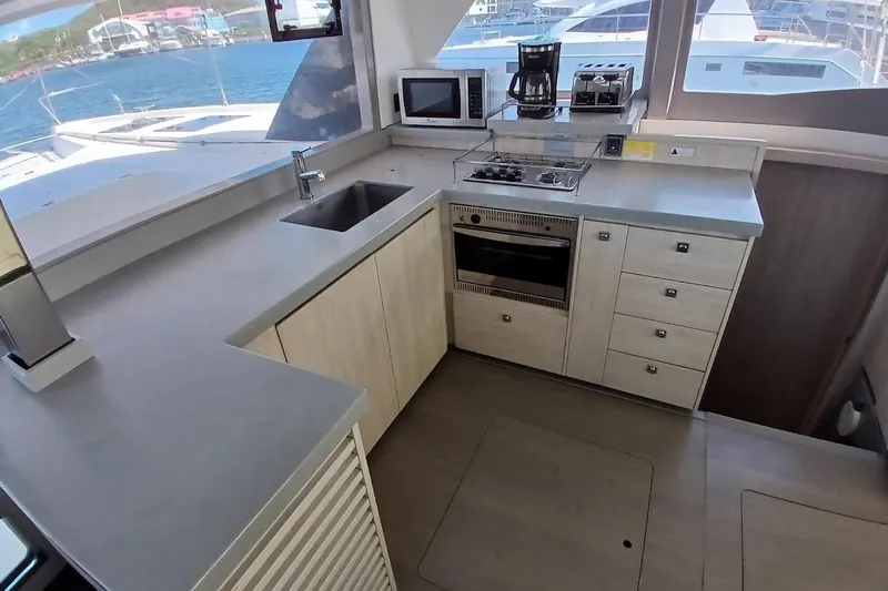 Mere Cat Yacht Photos Pics Modern kitchen interior on 2018 Leopard 45 yacht with appliances and ocean view.