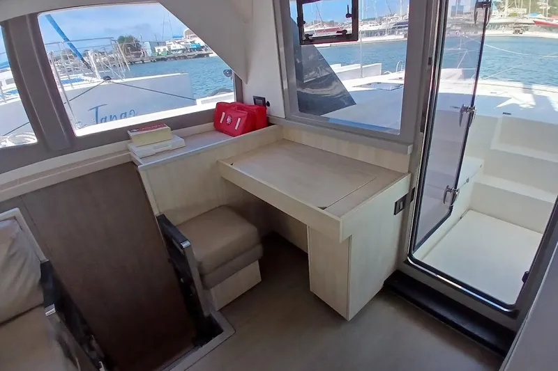 Mere Cat Yacht Photos Pics Interior of 2018 Leopard 45 catamaran with desk, window view, and outdoor access.