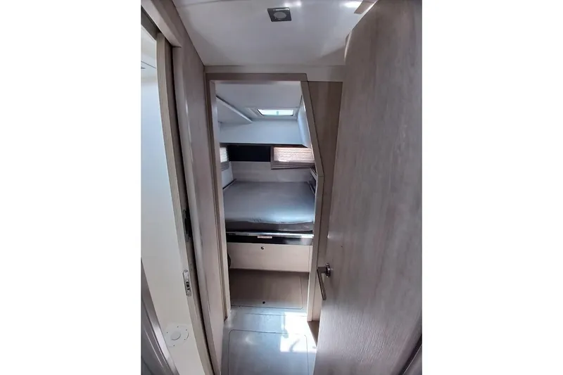 Mere Cat Yacht Photos Pics Interior cabin view of 2018 Leopard 45 catamaran, featuring a cozy bed and modern design.