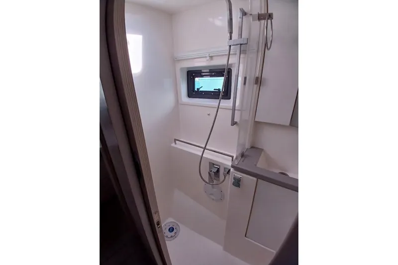 Mere Cat Yacht Photos Pics Compact shower area in 2018 Leopard 45 yacht with modern fixtures and window.
