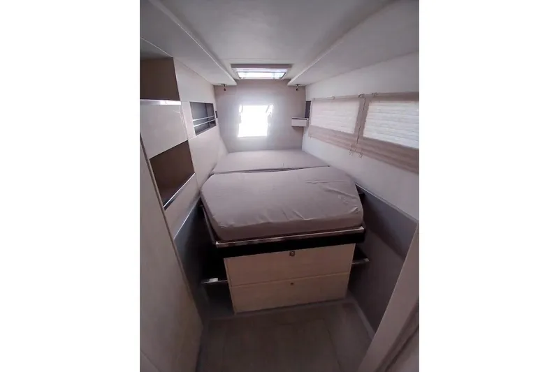Mere Cat Yacht Photos Pics Compact bedroom interior of 2018 Leopard 45 yacht with bed and storage.