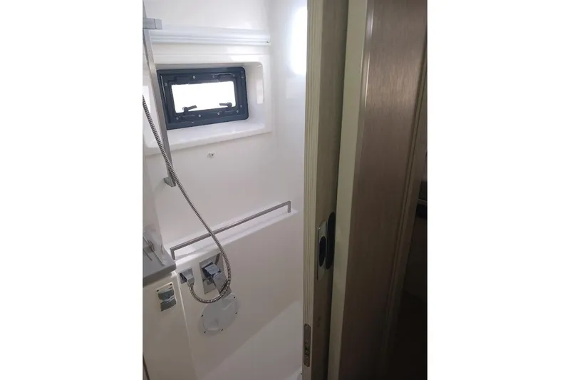 Mere Cat Yacht Photos Pics Compact bathroom in a 2018 Leopard 45 yacht, featuring a shower and window.