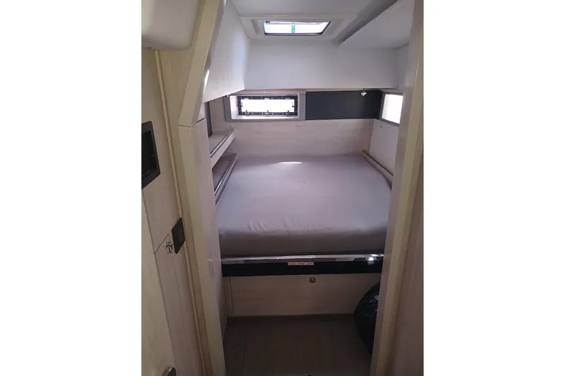 Mere Cat Yacht Photos Pics Cozy cabin interior of 2018 Leopard 45 yacht with bed and windows.