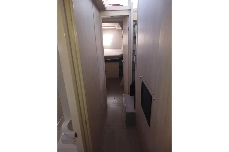 Mere Cat Yacht Photos Pics Narrow hallway inside 2018 Leopard 45 yacht, featuring modern interior design.