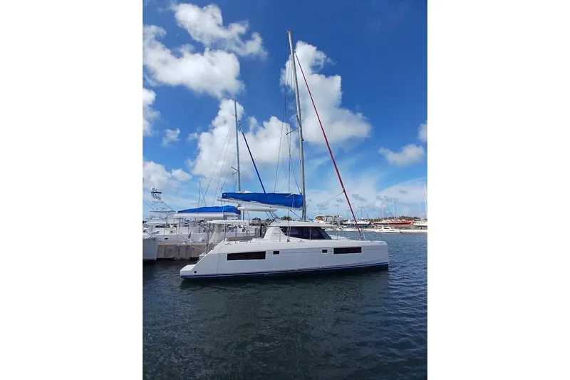 Mere Cat Yacht Photos Pics 2018 Leopard 45 catamaran docked in marina under clear blue sky.