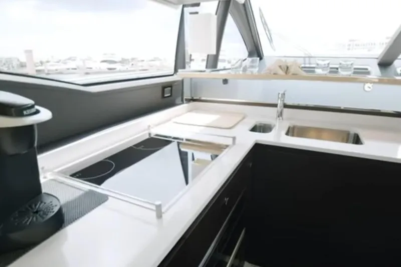 No Name Yacht Photos Pics Modern kitchen interior on 2017 Azimut 66 yacht, featuring sleek countertops and appliances.