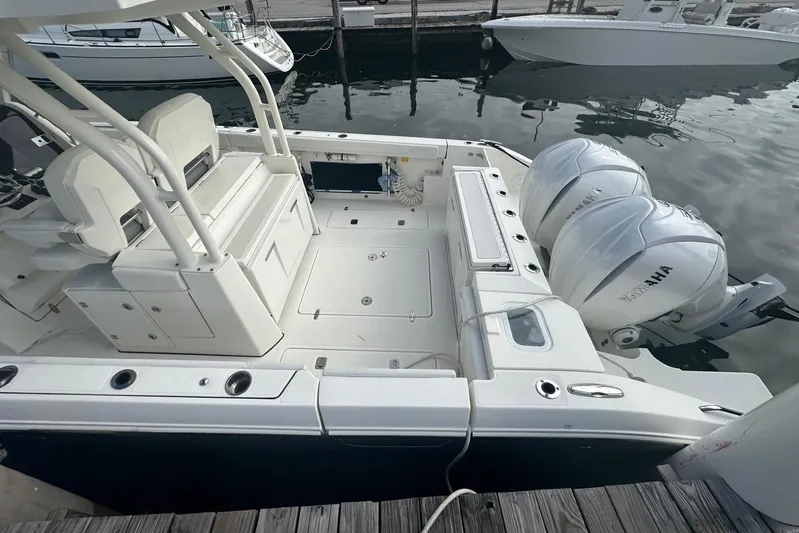  Yacht Photos Pics 2023 Pursuit S 328 Sport boat with dual Yamaha engines docked at marina.