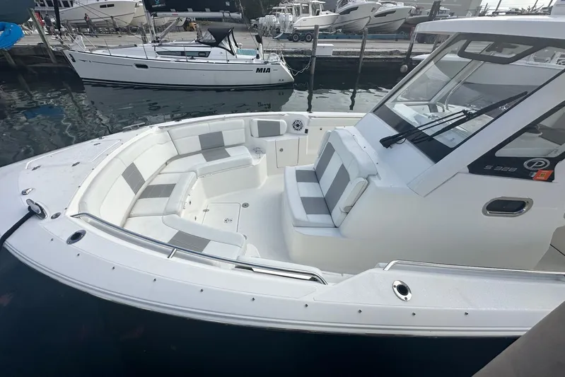  Yacht Photos Pics 2023 Pursuit S 328 Sport boat with spacious seating at a marina.