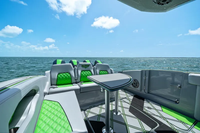  Yacht Photos Pics Luxurious 2026 Deep Impact 399 Sport boat interior with green accents, ocean view, and clear sky.