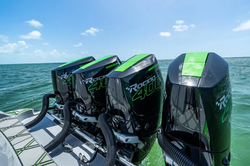  Yacht Photos Pics Four powerful outboard motors on a 2026 Deep Impact 399 Sport boat in open water.
