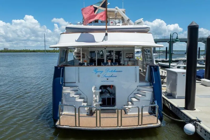 Flying Dutchman Yacht Photos Pics Luxury 1984 Lloyds Ships Tri-Deck yacht docked at marina under clear blue sky.