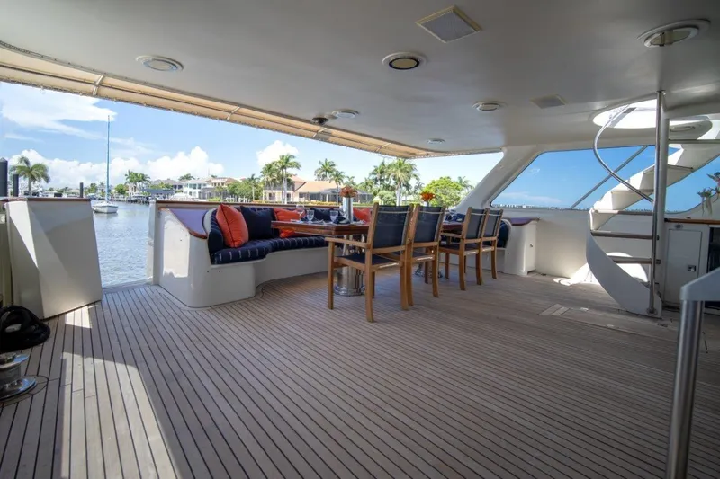 Flying Dutchman Yacht Photos Pics Luxurious 1984 Lloyds Ships Tri-Deck yacht with elegant outdoor seating and scenic waterfront view.