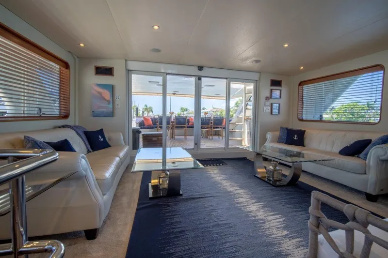 Flying Dutchman Yacht Photos Pics Luxurious 1984 Lloyds Ships Tri-Deck yacht interior with elegant seating and glass doors.