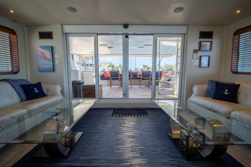 Flying Dutchman Yacht Photos Pics Luxurious 1984 Lloyds Ships Tri-Deck yacht interior with elegant seating and glass doors to deck.