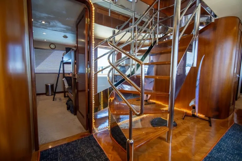 Flying Dutchman Yacht Photos Pics Luxurious interior of 1984 Lloyds Ships Tri-Deck yacht with elegant staircase and wood finishes.