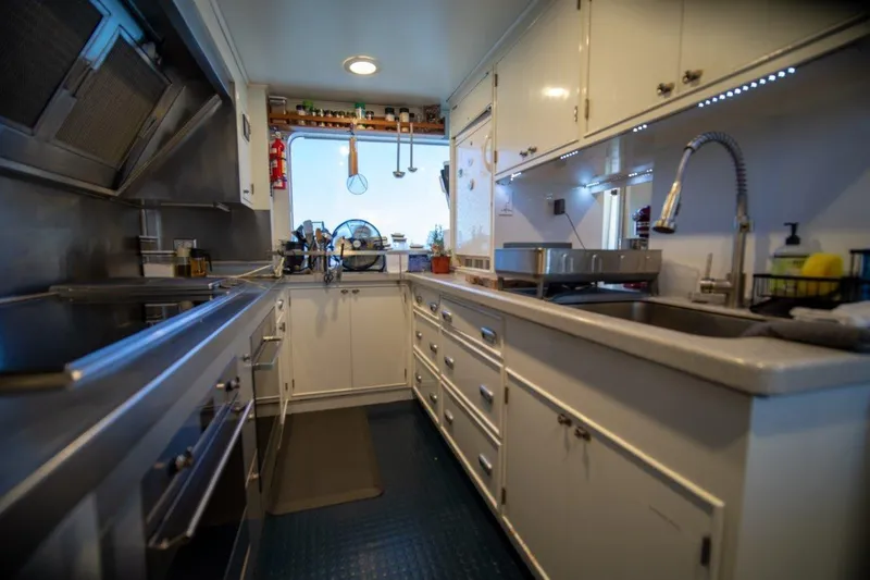 Flying Dutchman Yacht Photos Pics Luxurious 1984 Lloyds Ships Tri-Deck yacht kitchen with modern appliances and sleek design.