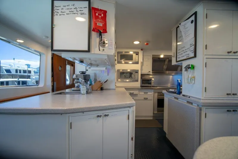 Flying Dutchman Yacht Photos Pics Luxurious 1984 Lloyds Ships Tri-Deck yacht kitchen with modern appliances and ample counter space.