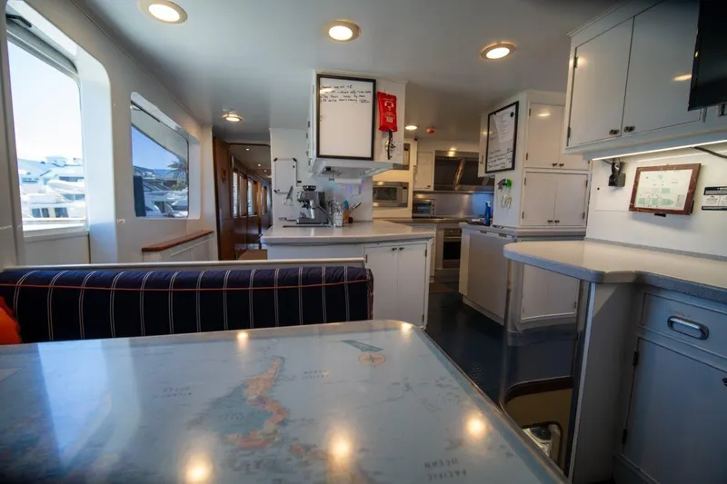 Flying Dutchman Yacht Photos Pics Interior of 1984 Lloyds Ships Tri-Deck yacht, featuring a modern kitchen and dining area.