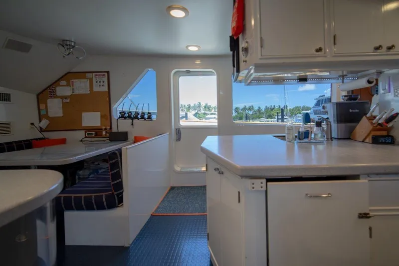 Flying Dutchman Yacht Photos Pics Interior of 1984 Lloyds Ships Tri-Deck yacht with kitchen and dining area, featuring ocean view.