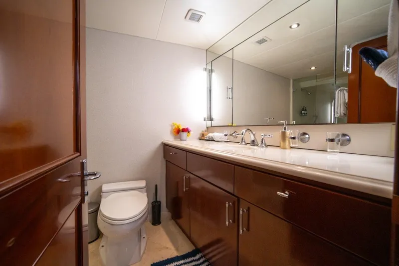 Flying Dutchman Yacht Photos Pics Luxurious 1984 Lloyds Ships Tri-Deck yacht bathroom with elegant wood cabinetry and modern fixtures.