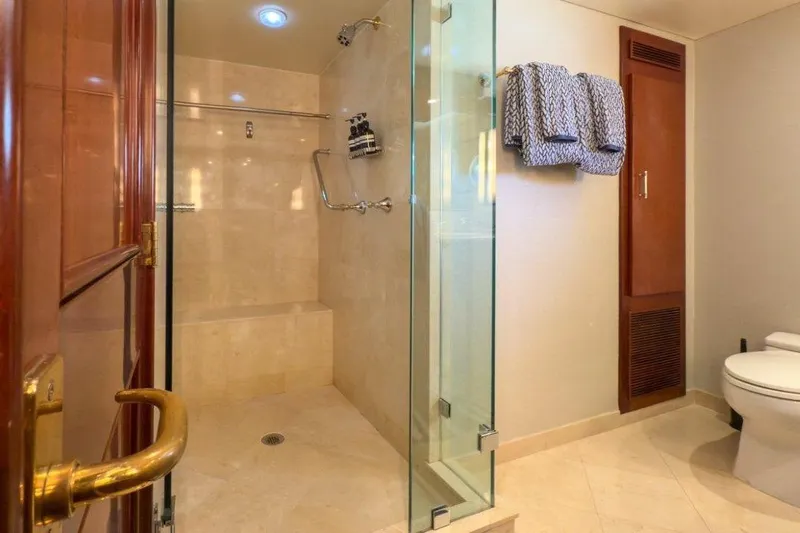 Flying Dutchman Yacht Photos Pics Luxurious bathroom on 1984 Lloyds Ships Tri-Deck yacht with glass shower and elegant fixtures.