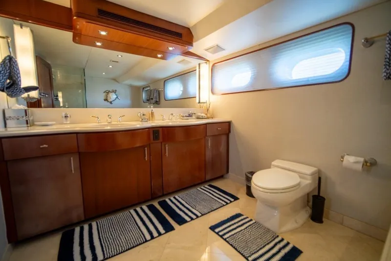 Flying Dutchman Yacht Photos Pics Luxurious yacht bathroom with wooden cabinetry, dual sinks, and nautical-themed decor, 1984 Lloyds Ships Tri-Deck.