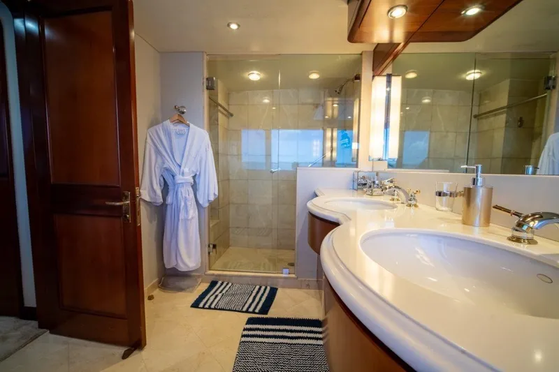 Flying Dutchman Yacht Photos Pics Luxurious bathroom on 1984 Lloyds Ships Tri-Deck yacht with double sinks and glass shower.