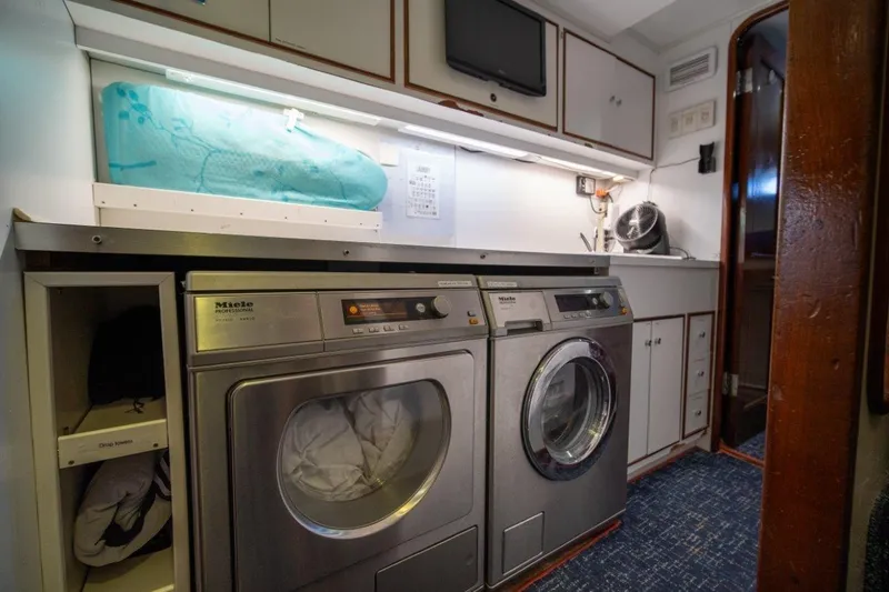 Flying Dutchman Yacht Photos Pics Laundry room on 1984 Lloyds Ships Tri-Deck yacht with Miele appliances and storage cabinets.