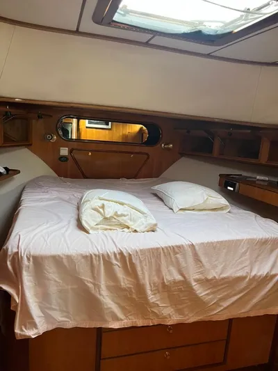 Warrior Yacht Photos Pics Cozy cabin interior of 2005 Albin 45 Command Bridge with bed and pillows.