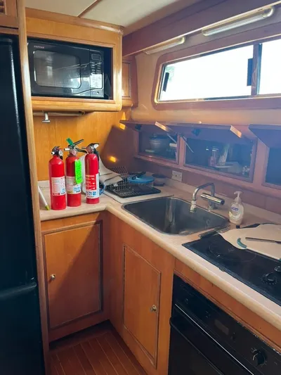 Warrior Yacht Photos Pics 2005 Albin 45 Command Bridge kitchen with fire extinguishers, microwave, and sink.