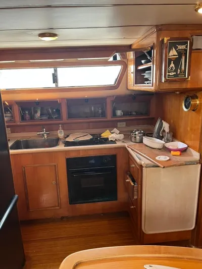 Warrior Yacht Photos Pics 2005 Albin 45 Command Bridge kitchen with wooden cabinetry and modern appliances.