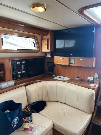 Warrior Yacht Photos Pics Interior of 2005 Albin 45 Command Bridge with seating, TV, and control panel.